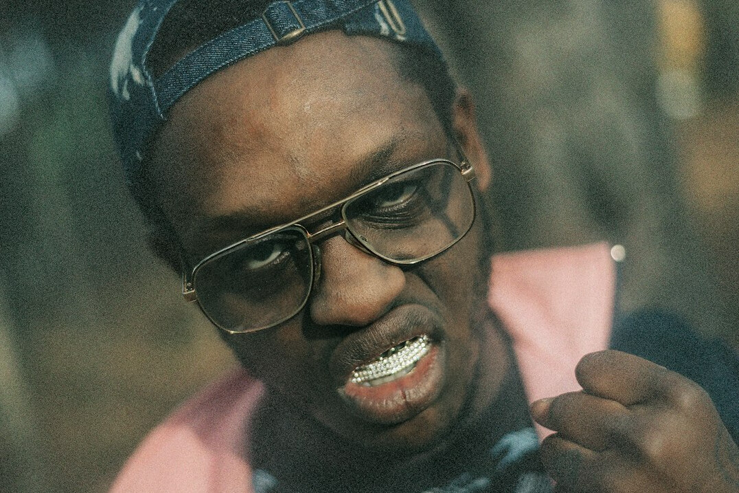 Studio portrait of a man with glasses smiling